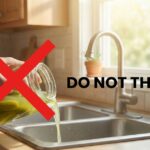 Hand Holding a jar of leftover pickle juice with a sign do not throw